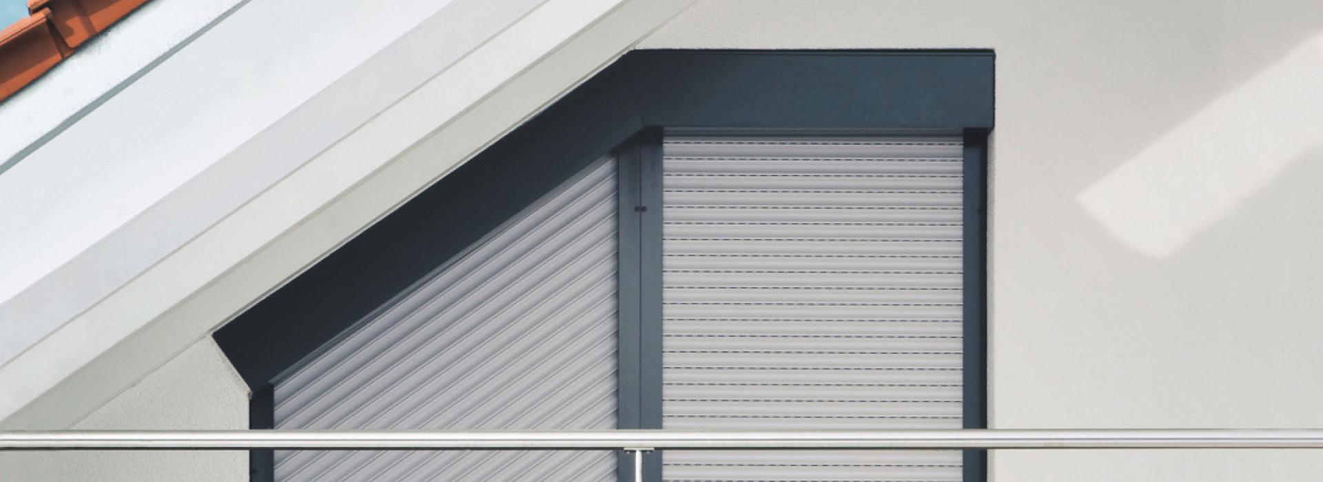 Window close-up roof slope with angled roller shutter TRENDO