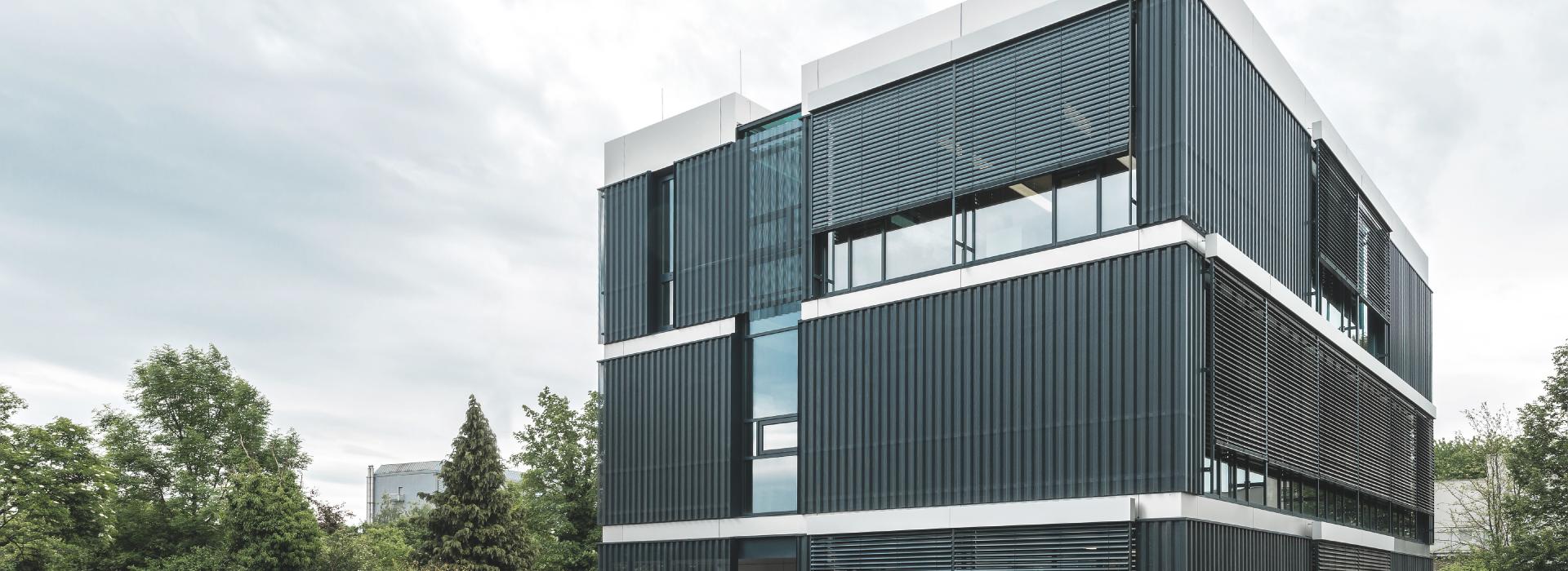 Modern office building with façade venetian blinds by daylight